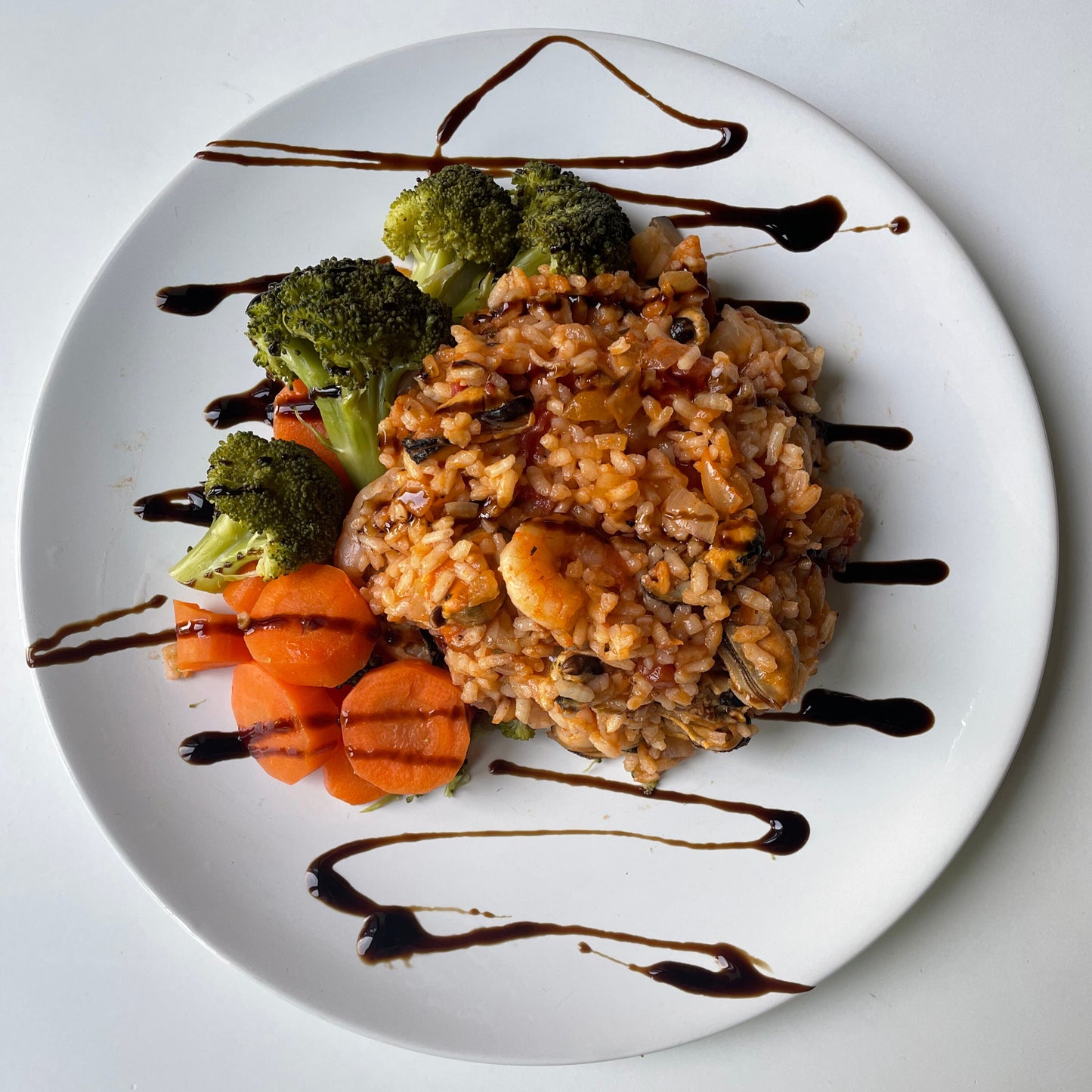 Spanish Paella and Seafood Medley w/ steamed spring greens